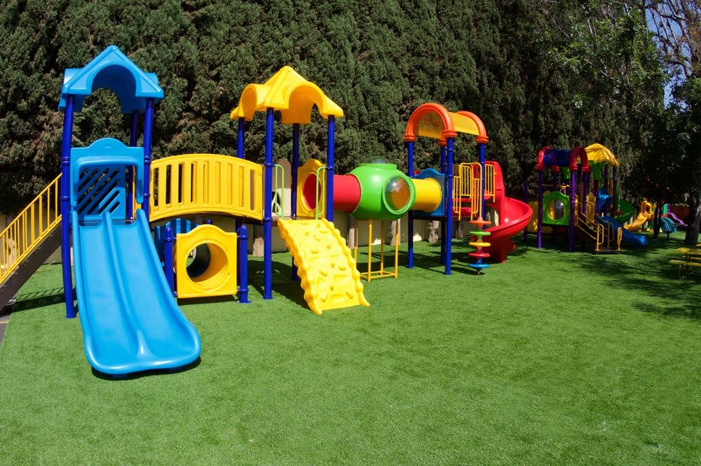 Colorful playground equipment on green grass
