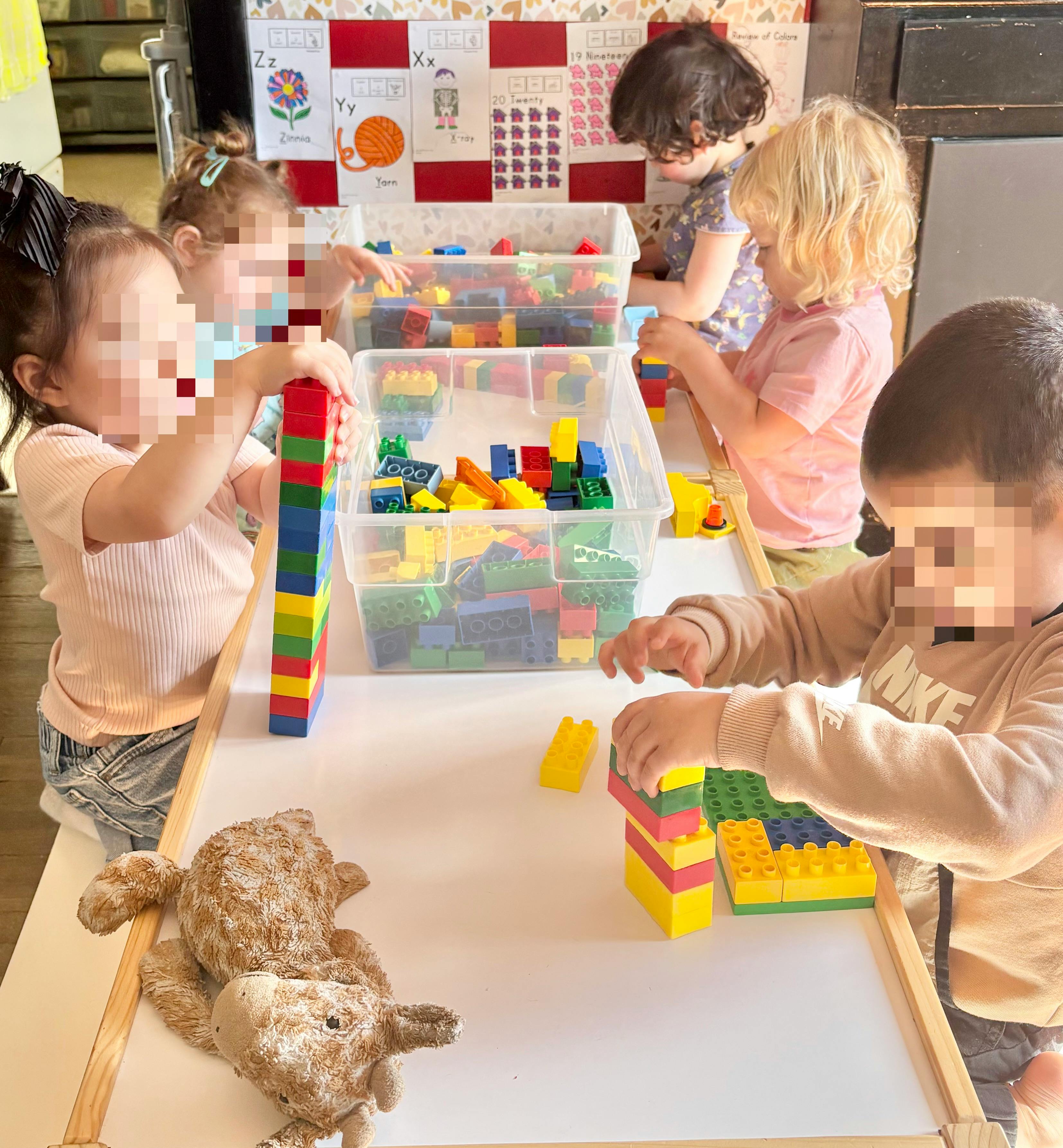 Children playing with colorful building blocks at a table
