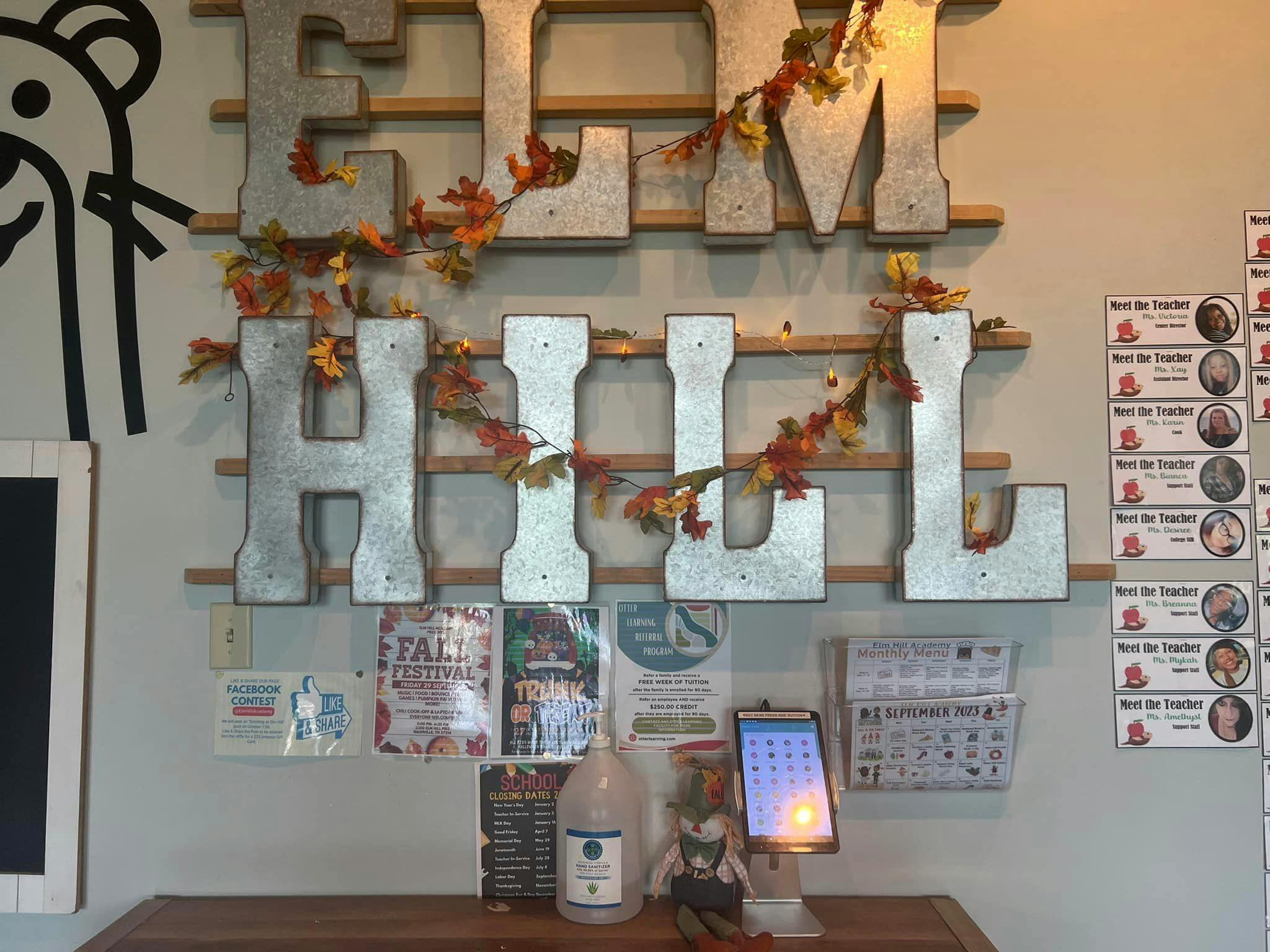 Wall decor with large letters spelling "HILL" and "LIVE" adorned with autumn leaves