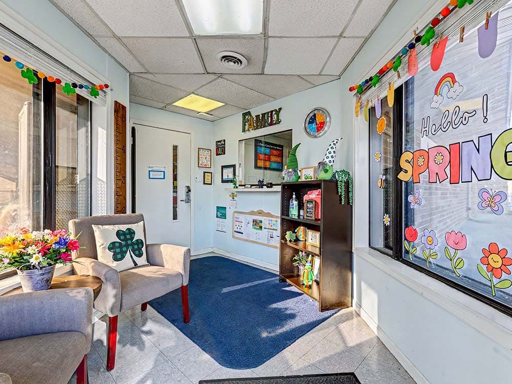 Reception area or waiting room decorated for spring with armchairs and a small shelf