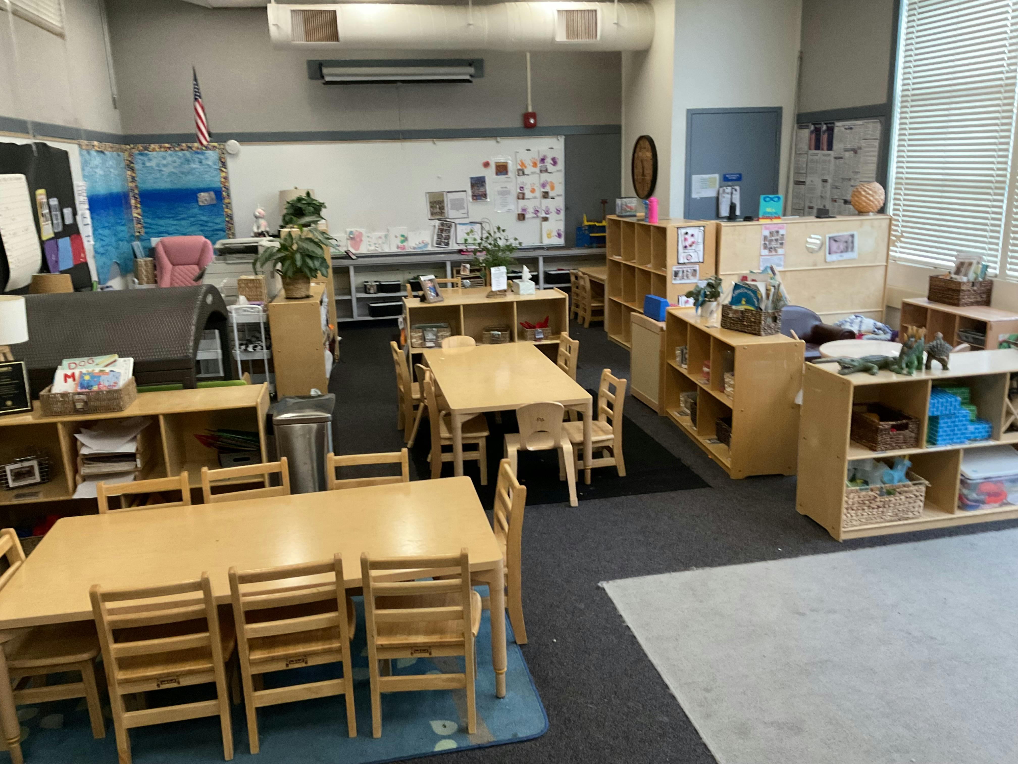 Empty classroom with small tables and chairs