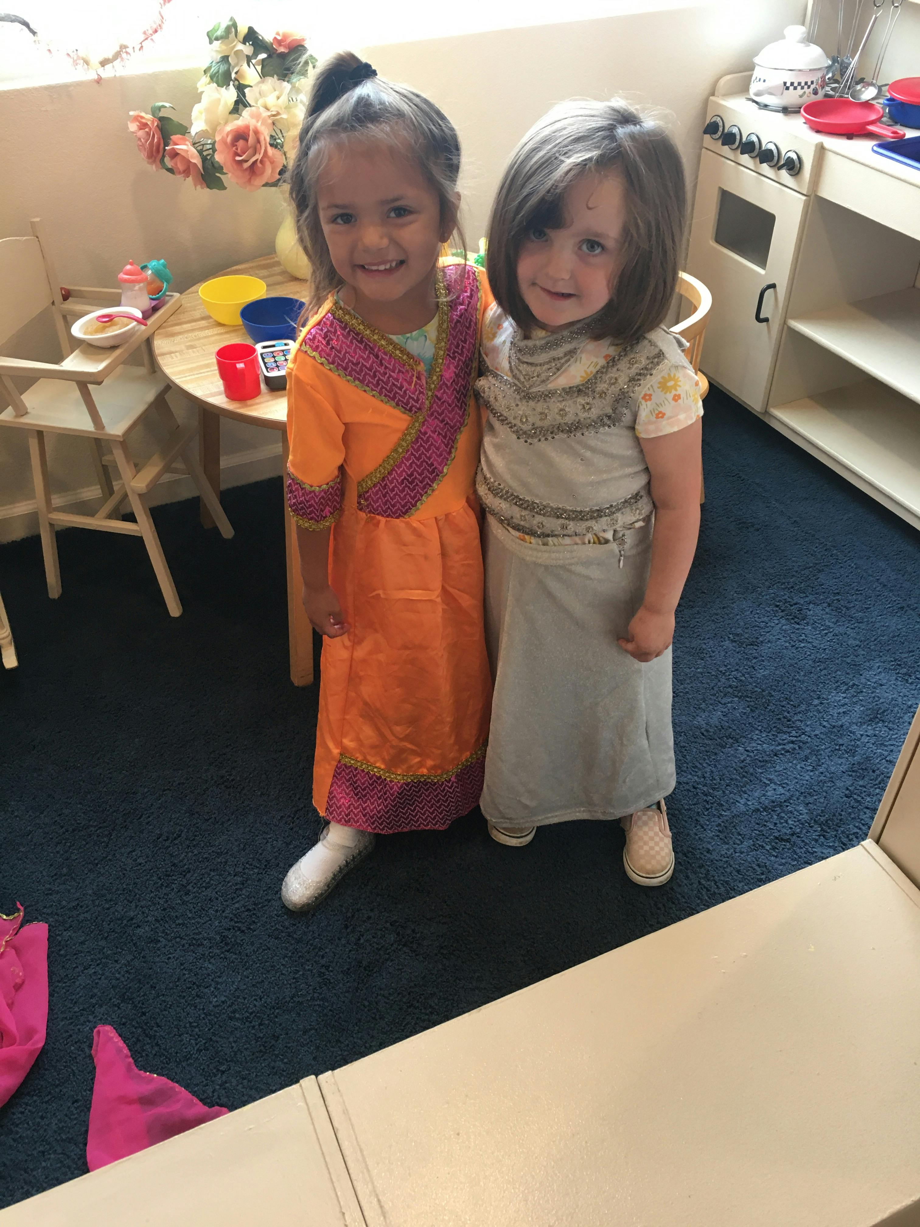 Two children standing together in a classroom