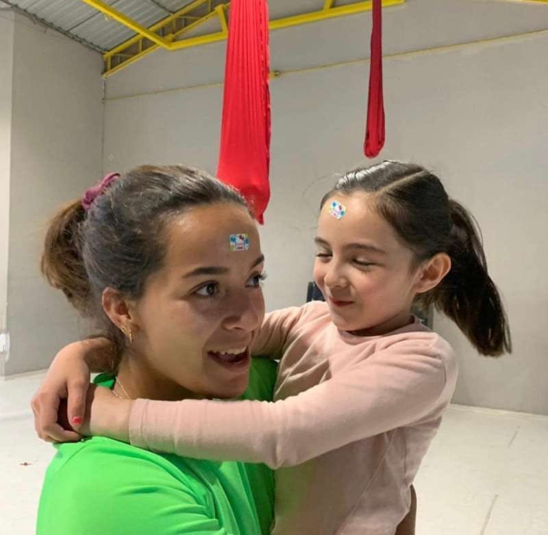 Person holding a child who is hugging them