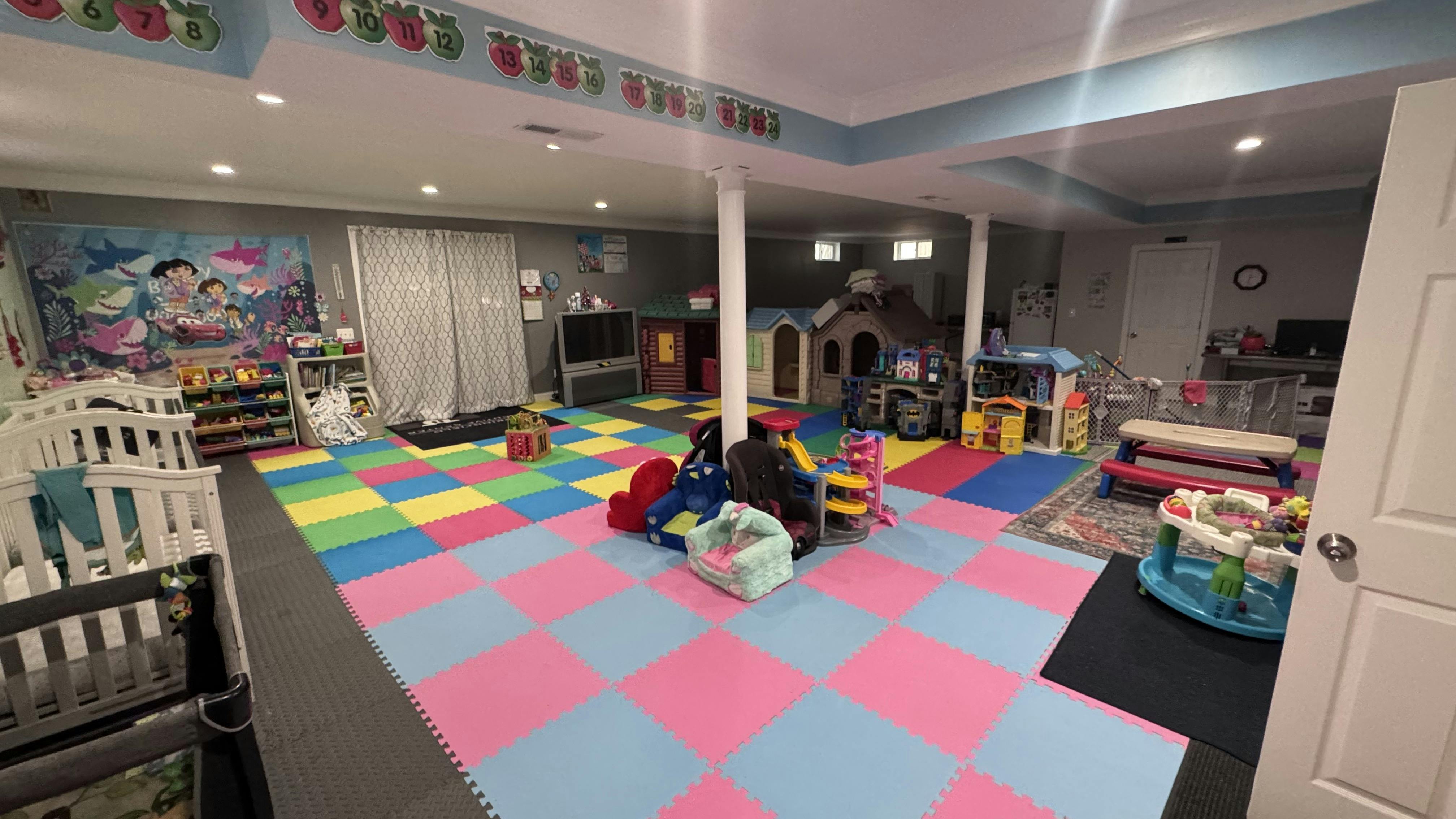 Playroom with colorful foam floor tiles and various toys