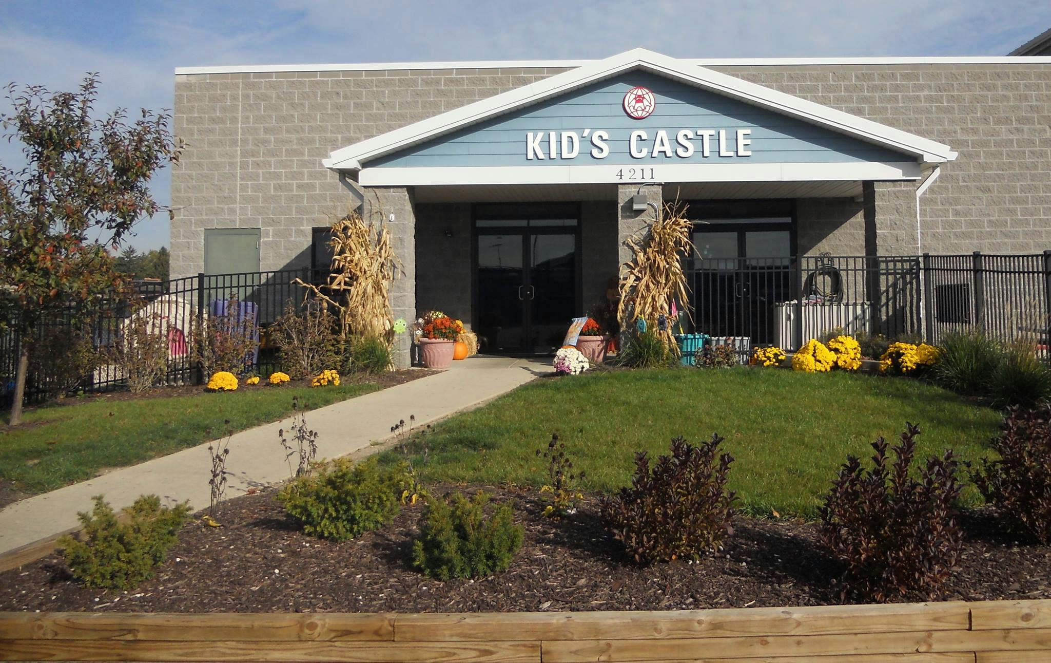 Building with "Kid's Castle" sign and autumn decorations