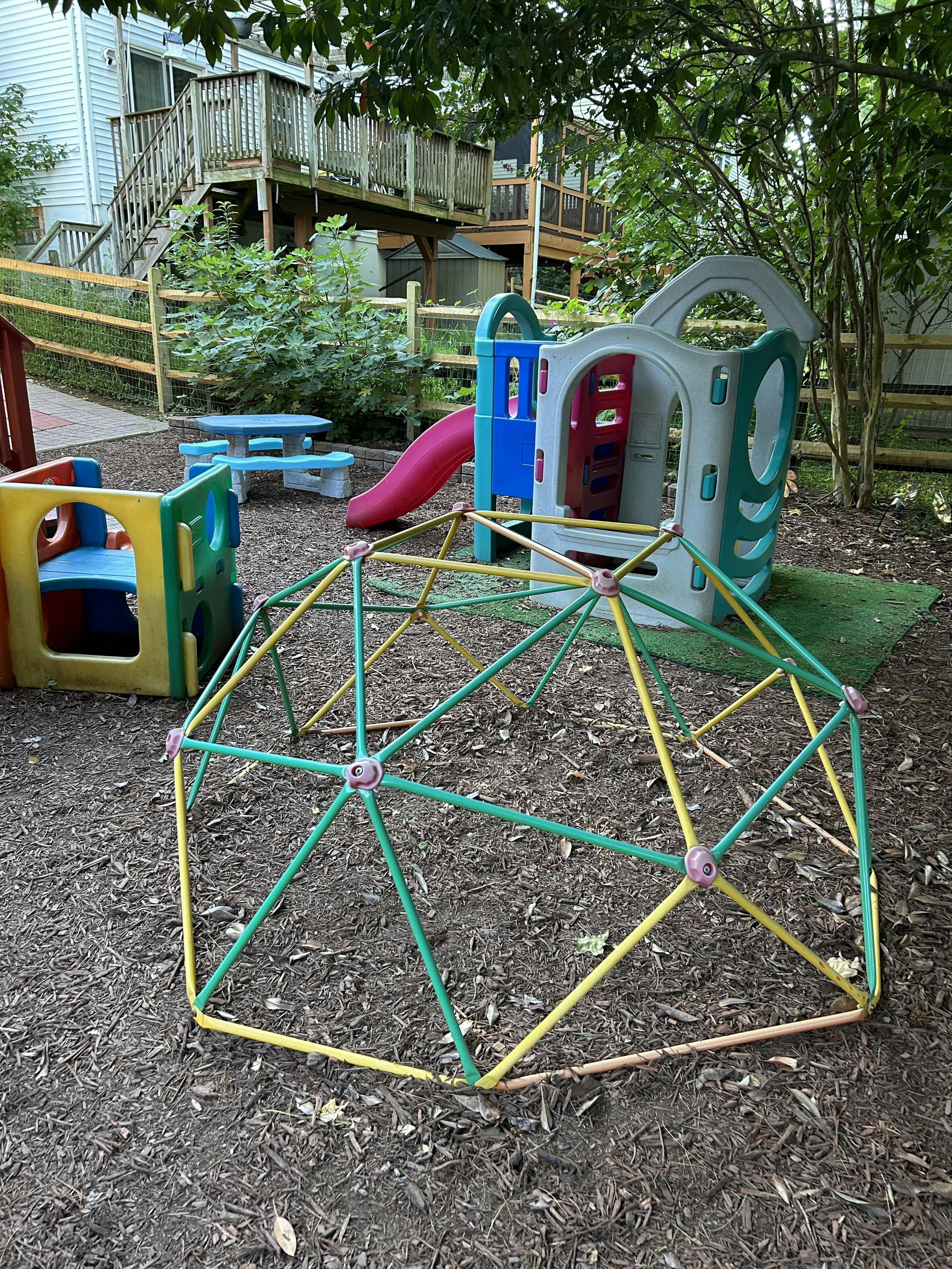 Playground with a climbing dome, slide, and play structure