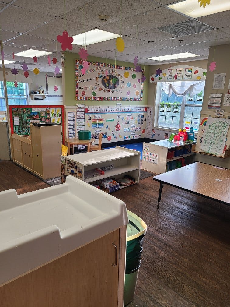 Classroom decorated with paper flowers and educational posters on the walls