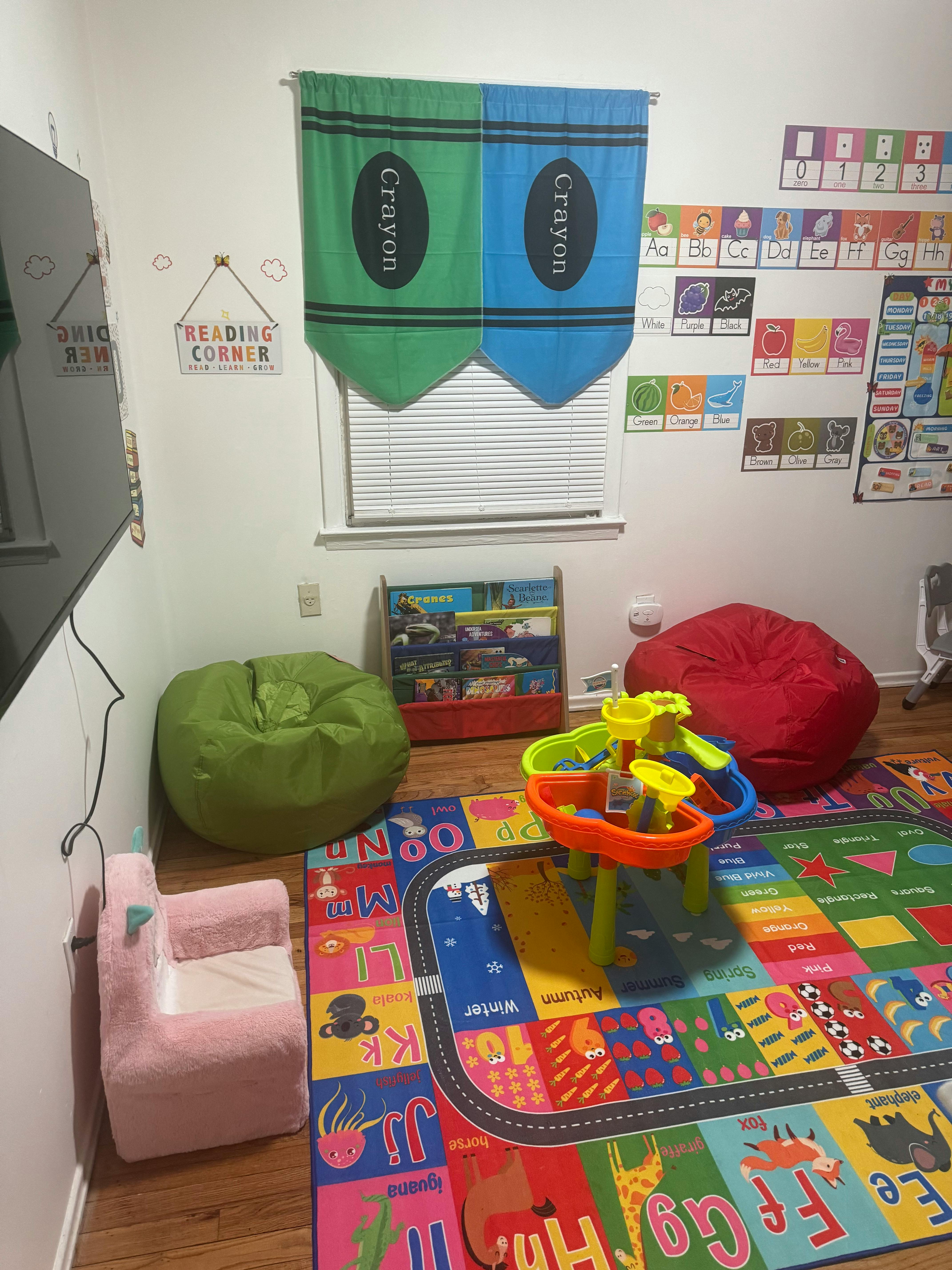 Playroom with colorful rug, bean bags, and crayon-themed window valance