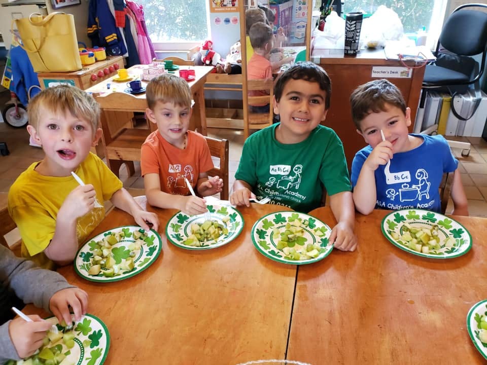 Four children eating at a table