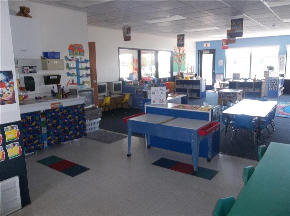 A colorful classroom with various learning stations and small tables