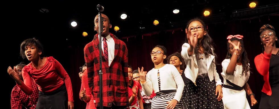 Group of people singing on stage