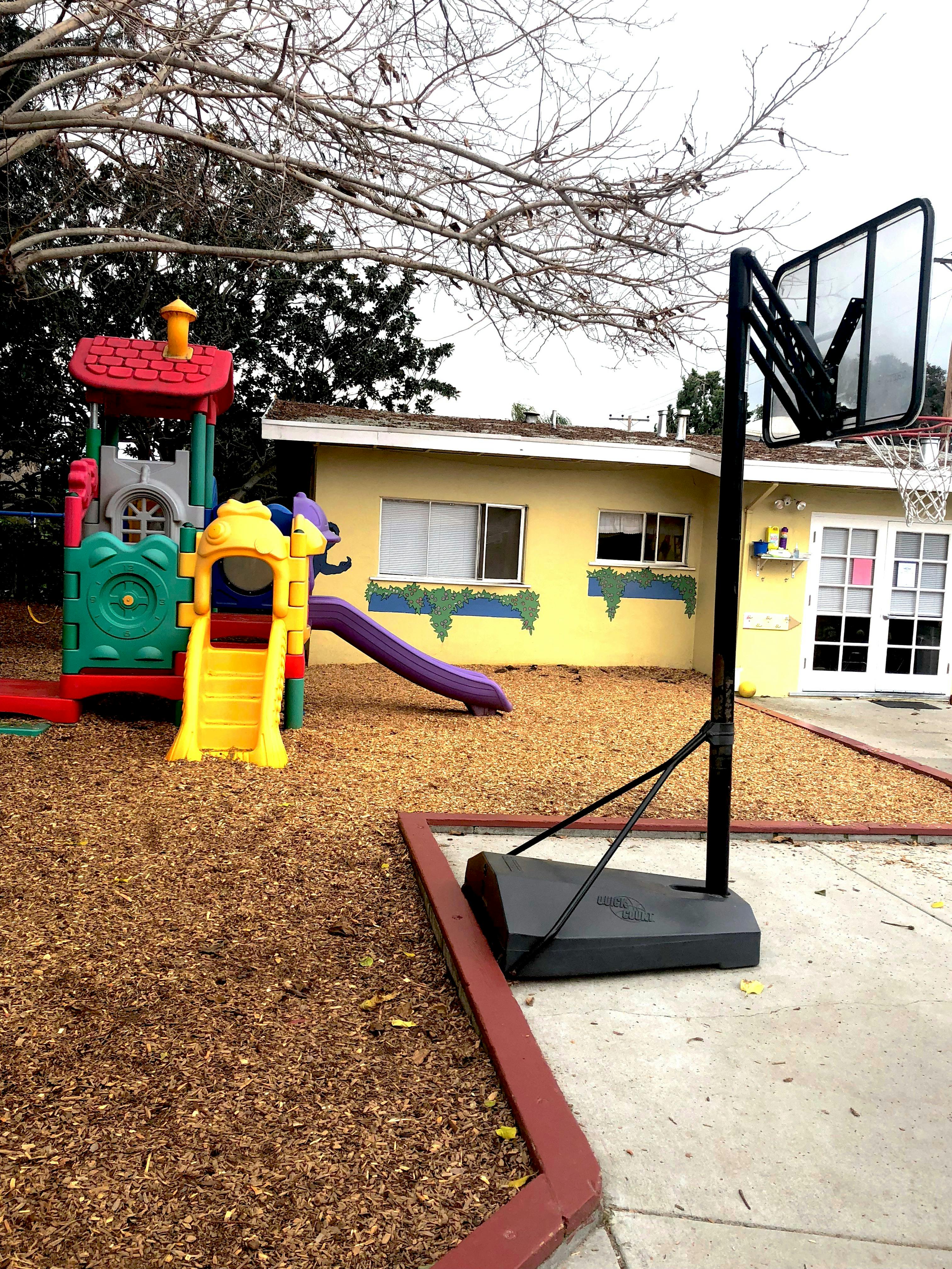 Playground with slides and a basketball hoop