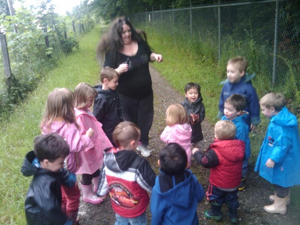 Adult person with a group of children outdoors