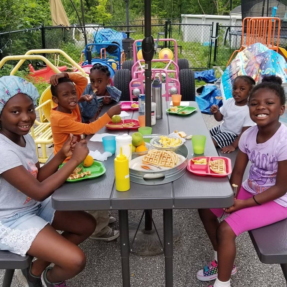 Children eating at an outdoor table
