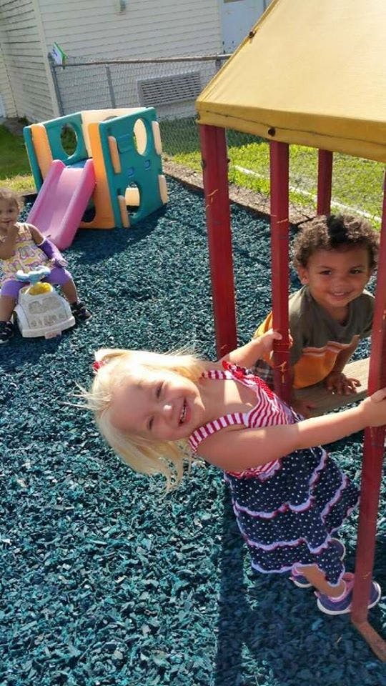 Three children playing on a playground