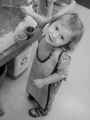 Child painting on an easel