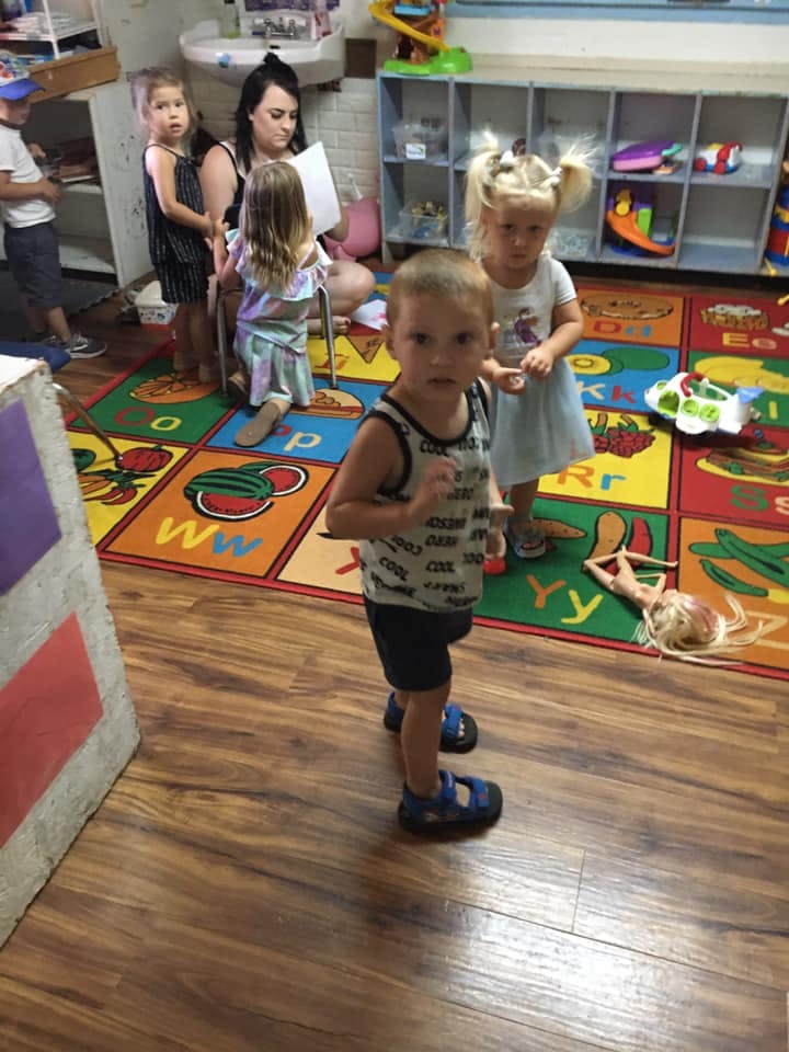 Children and an adult in a classroom