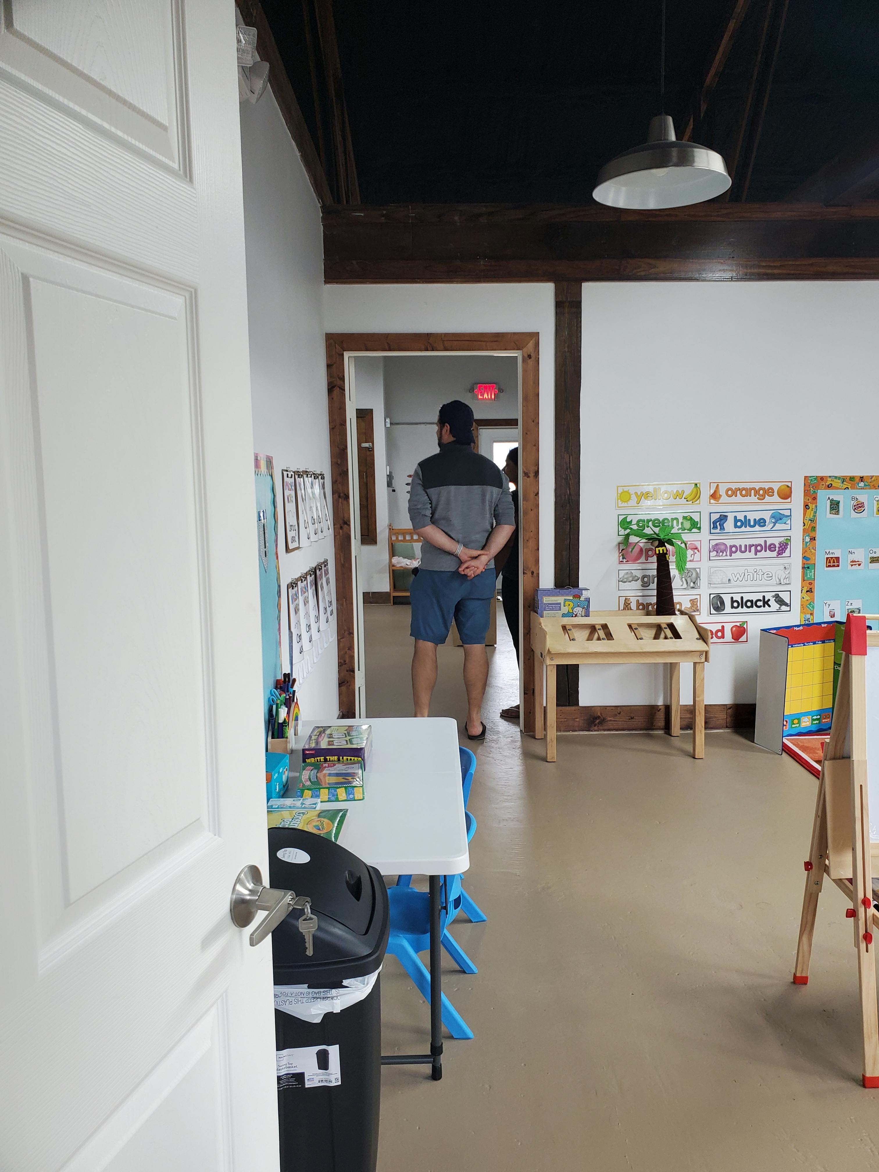 Person standing in a doorway looking into a room