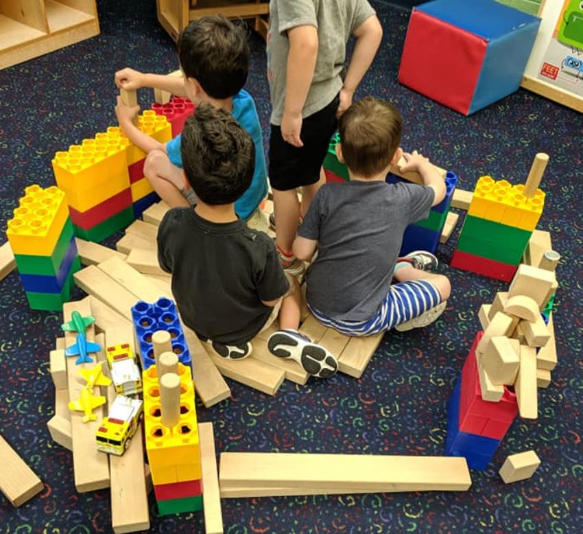 Children playing with building blocks on the floor