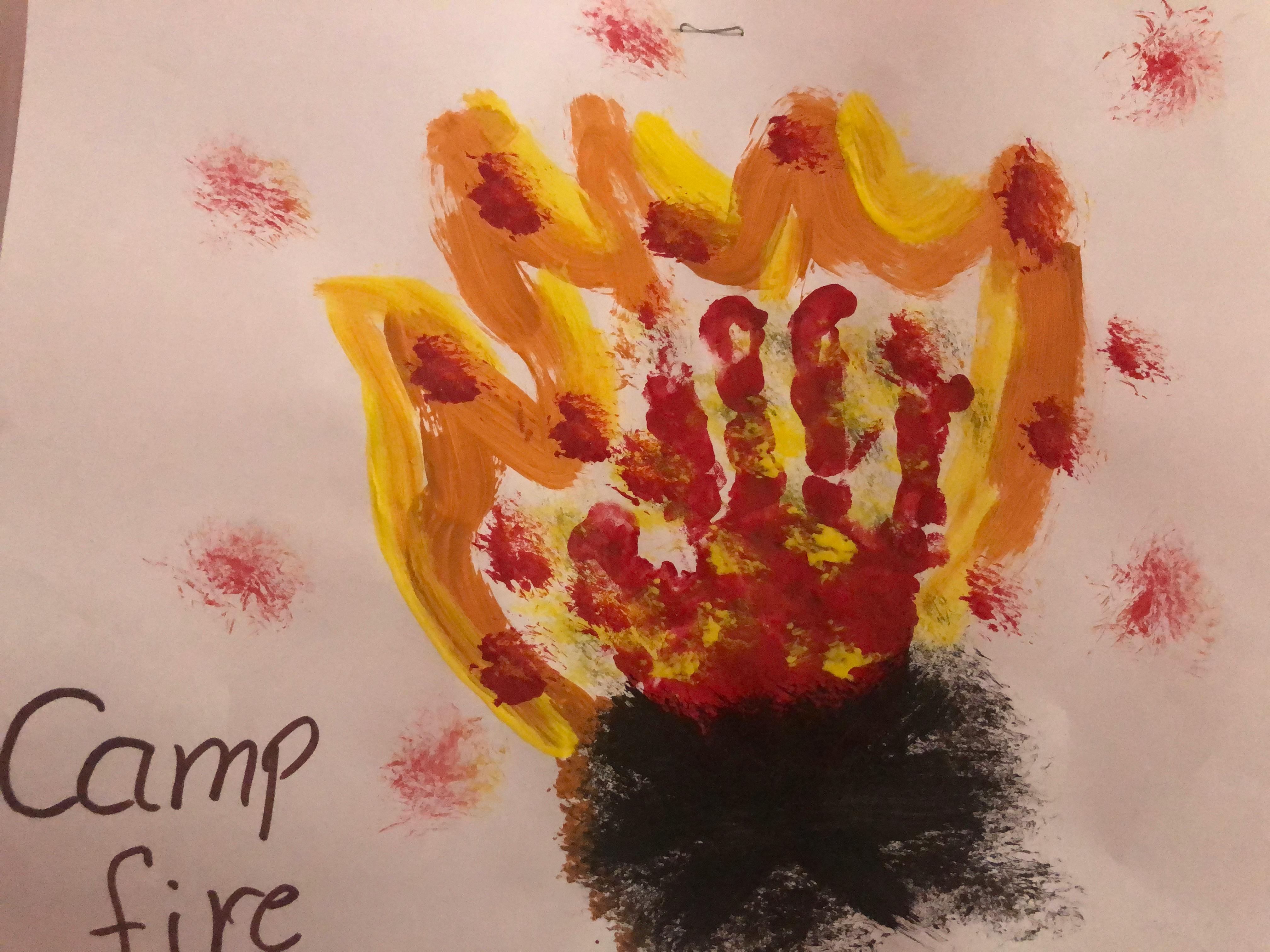 Child's handprint art of a campfire with text "Camp fire"