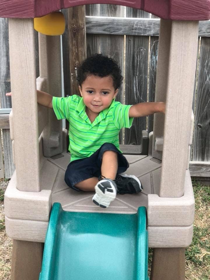 Child sitting on a playground slide
