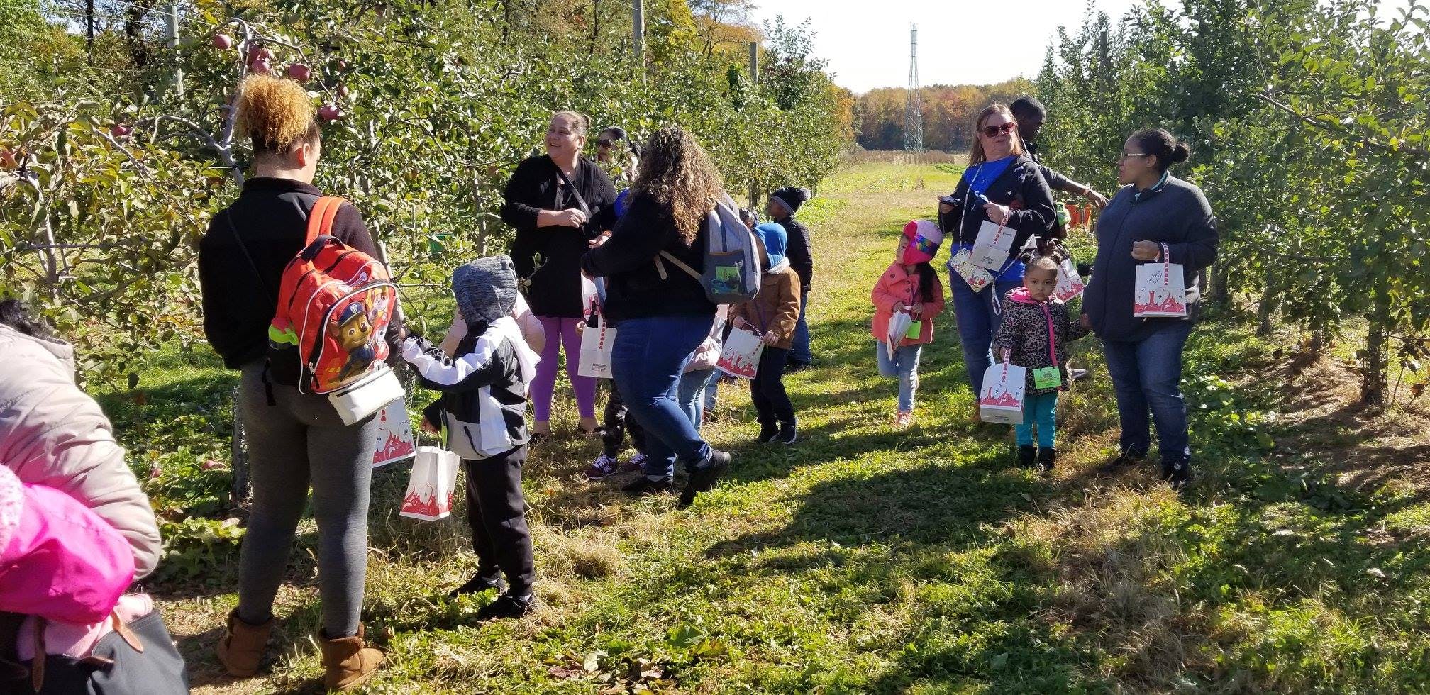 People and children in an orchard