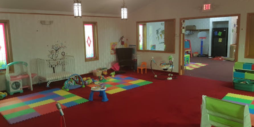 Playroom with colorful mats and toys on a red carpet