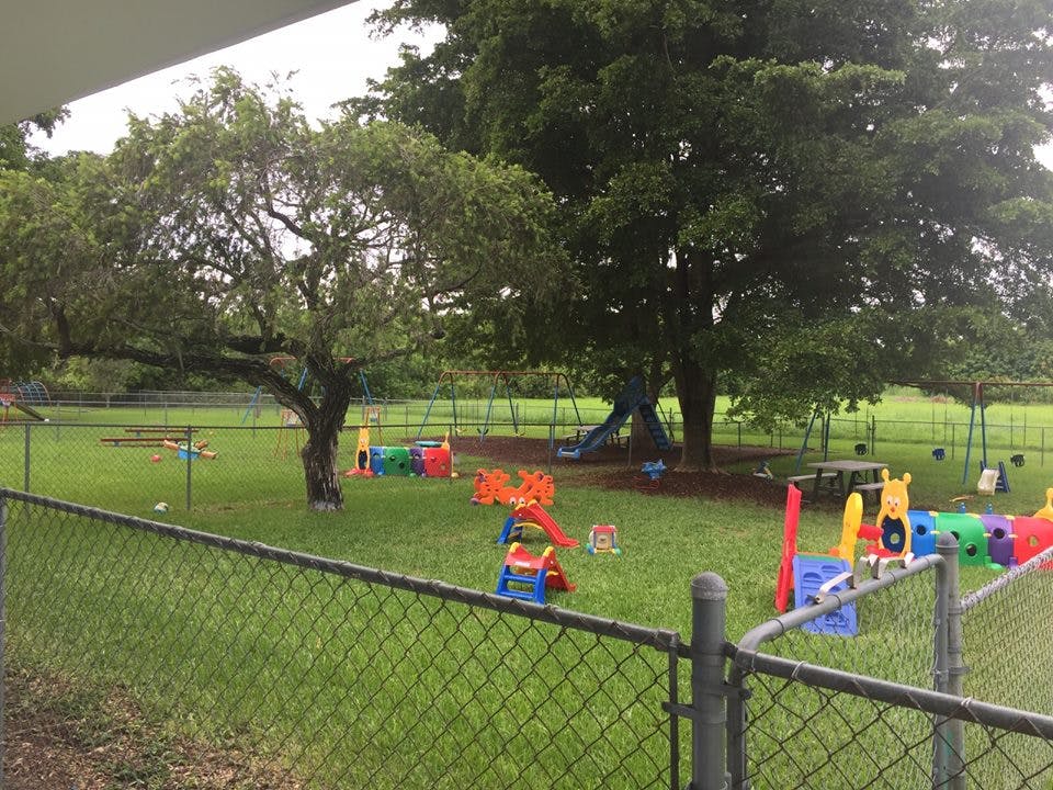 Playground with swings, slides, and colorful play equipment on grass