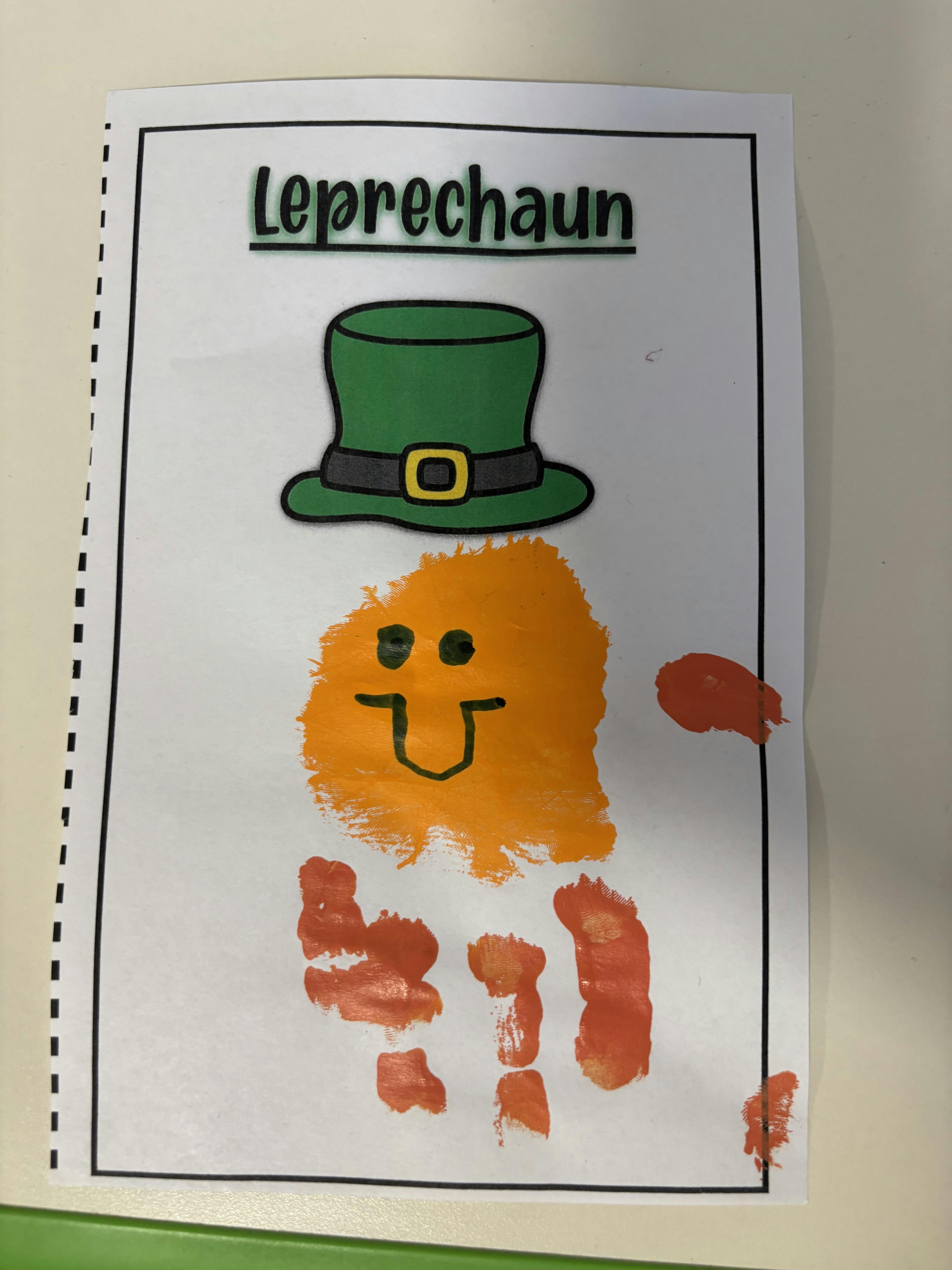 Leprechaun-themed child's art print with a green hat and orange paint for the face and body