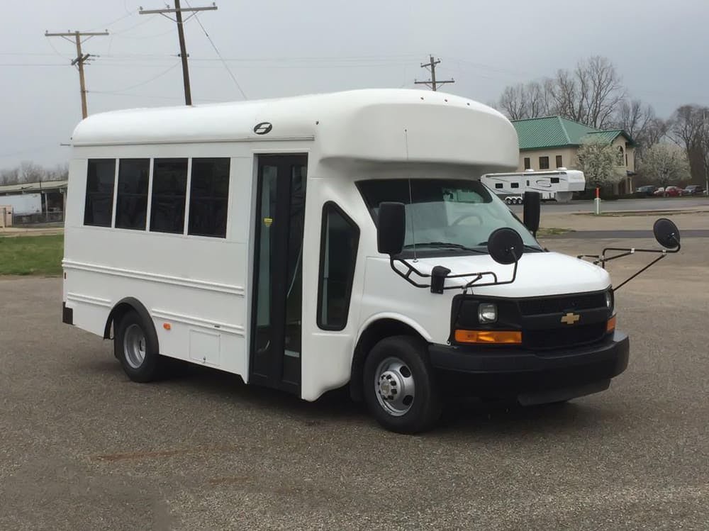White shuttle bus with an open door