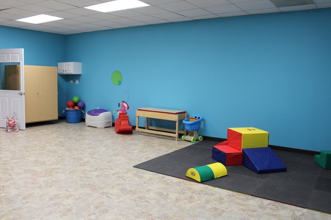 Playroom with blue walls and colorful soft play equipment