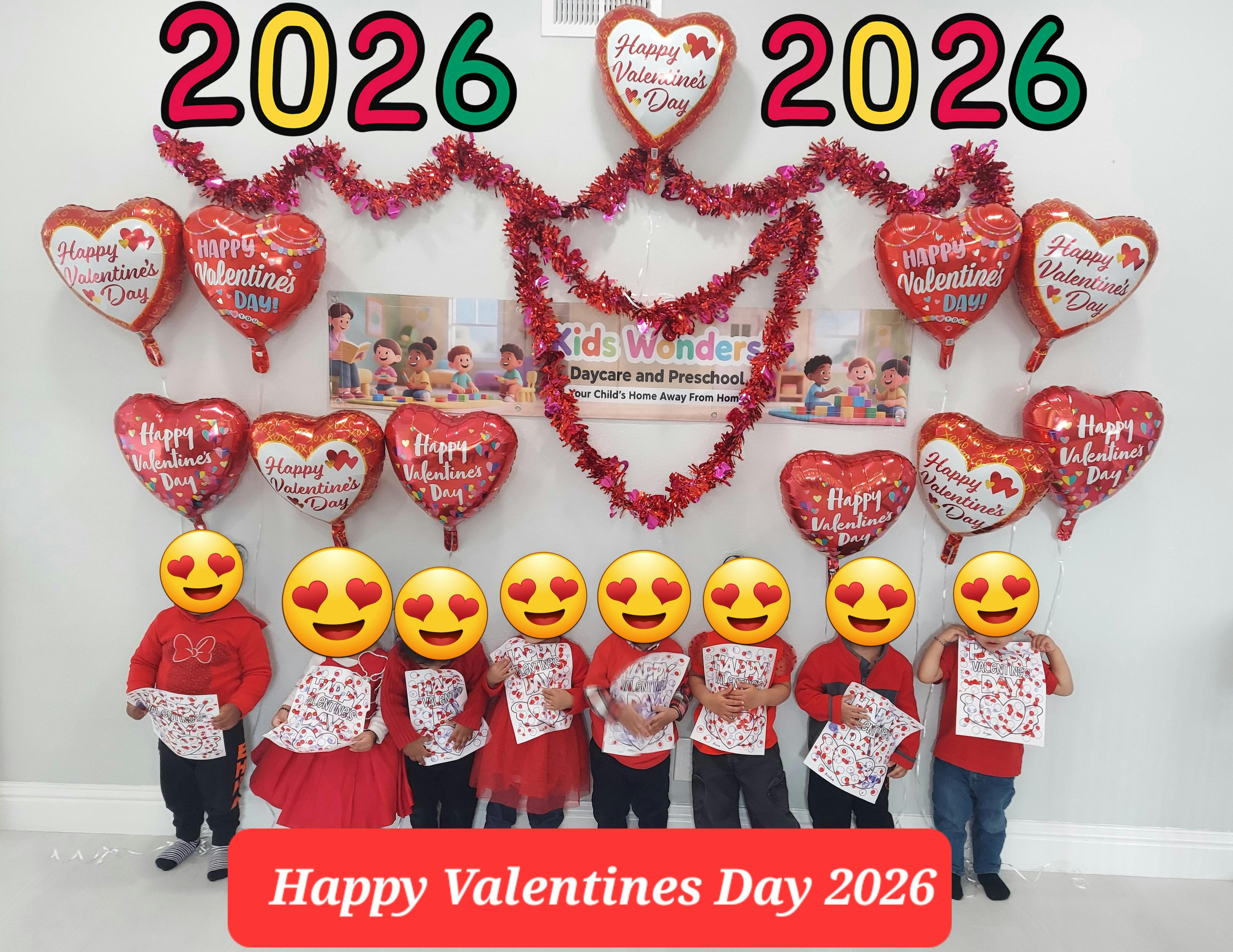 children holding Valentine's Day art, surrounded by heart balloons and "2026" text