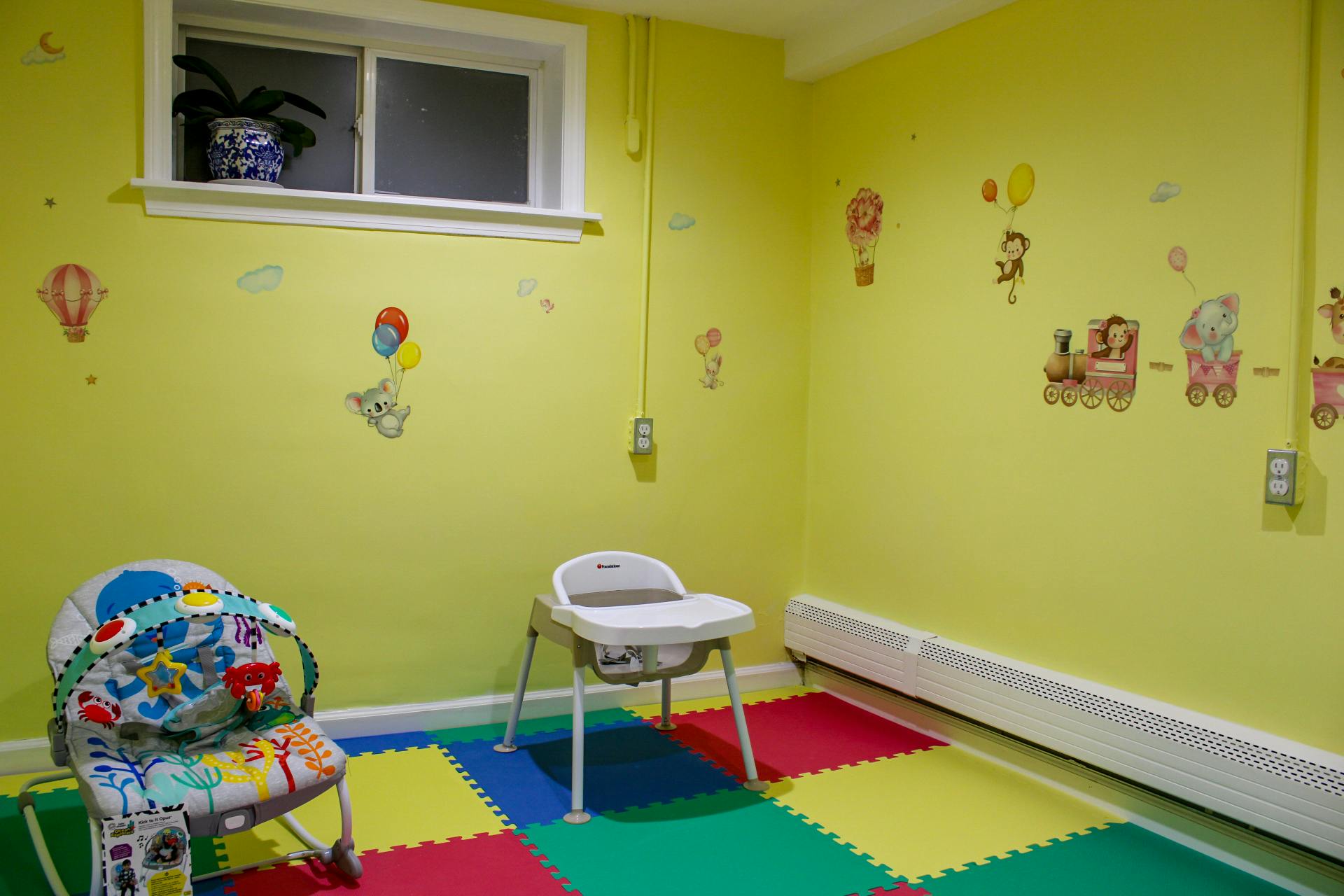 Child's room with play mat, baby bouncer, and high chair