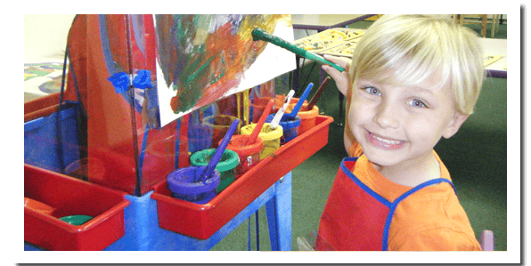 Child painting on an easel