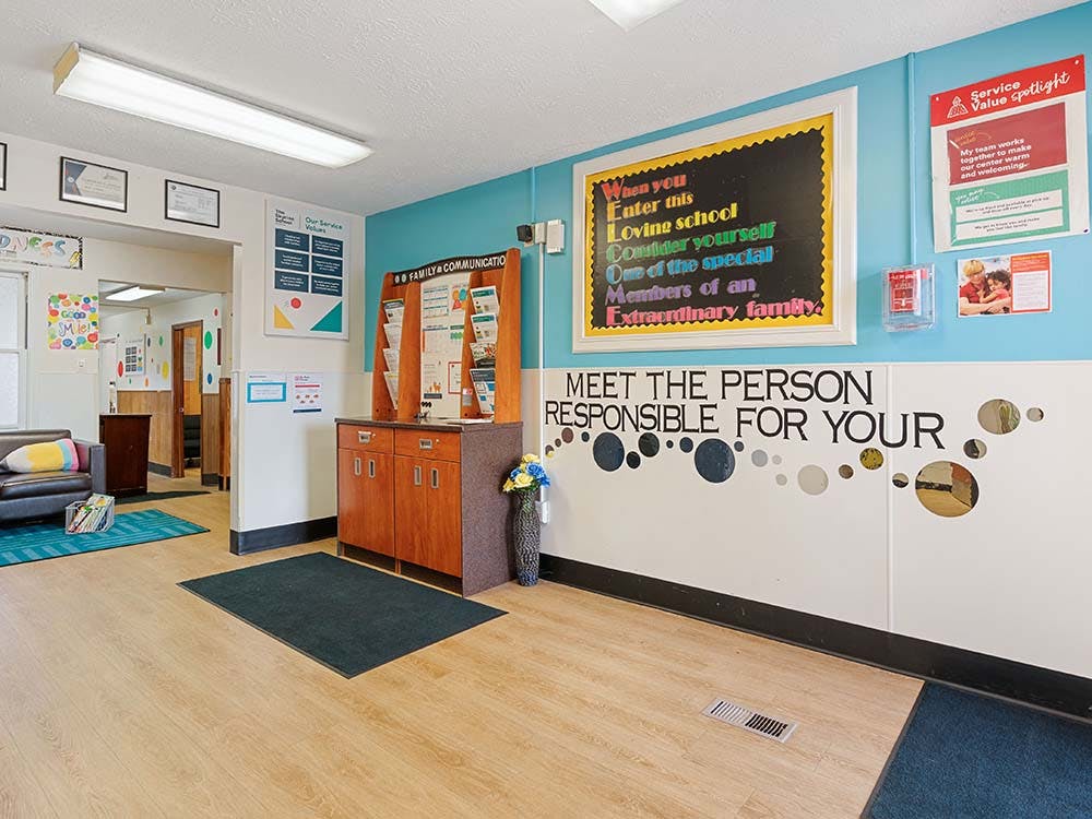 school hallway with inspirational messages on the wall, and a cabinet
