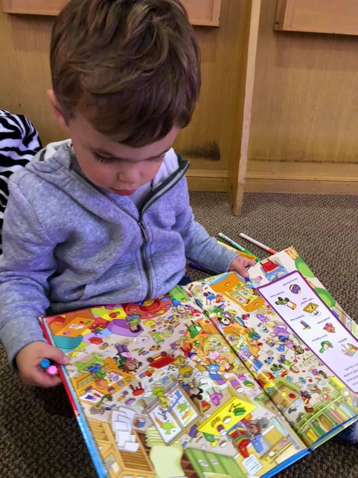 Child looking at a colorful book