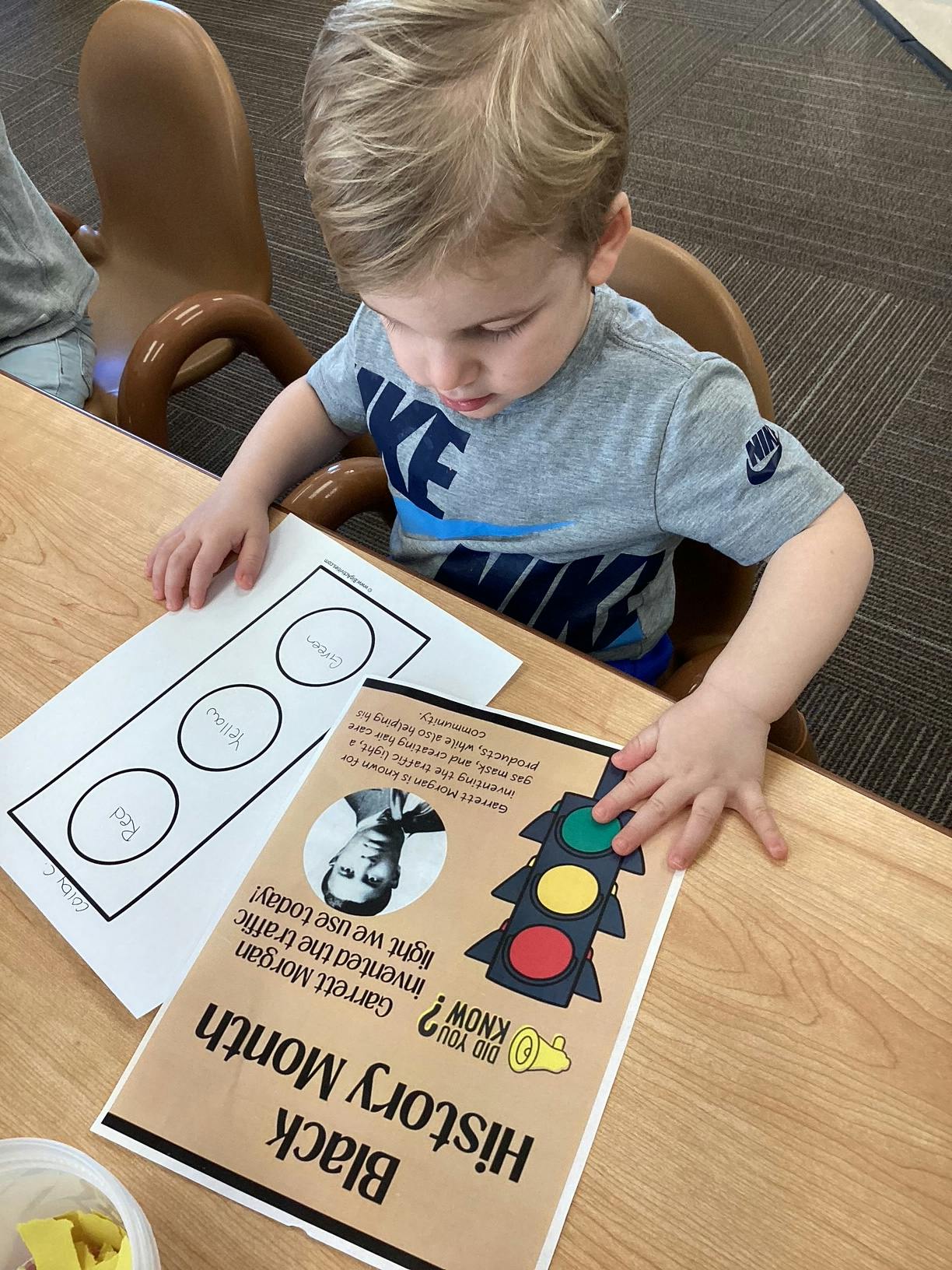 Child looking at a "Black History Month" sign
