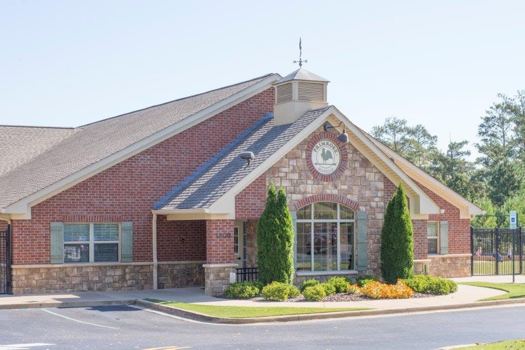 Brick and stone building with a large window and landscaping