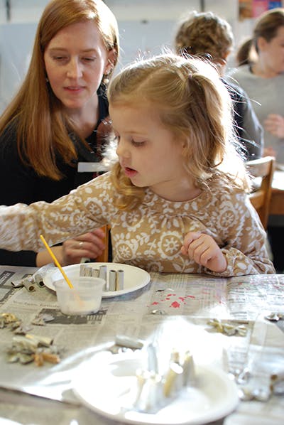 Adult and child at a table with craft supplies