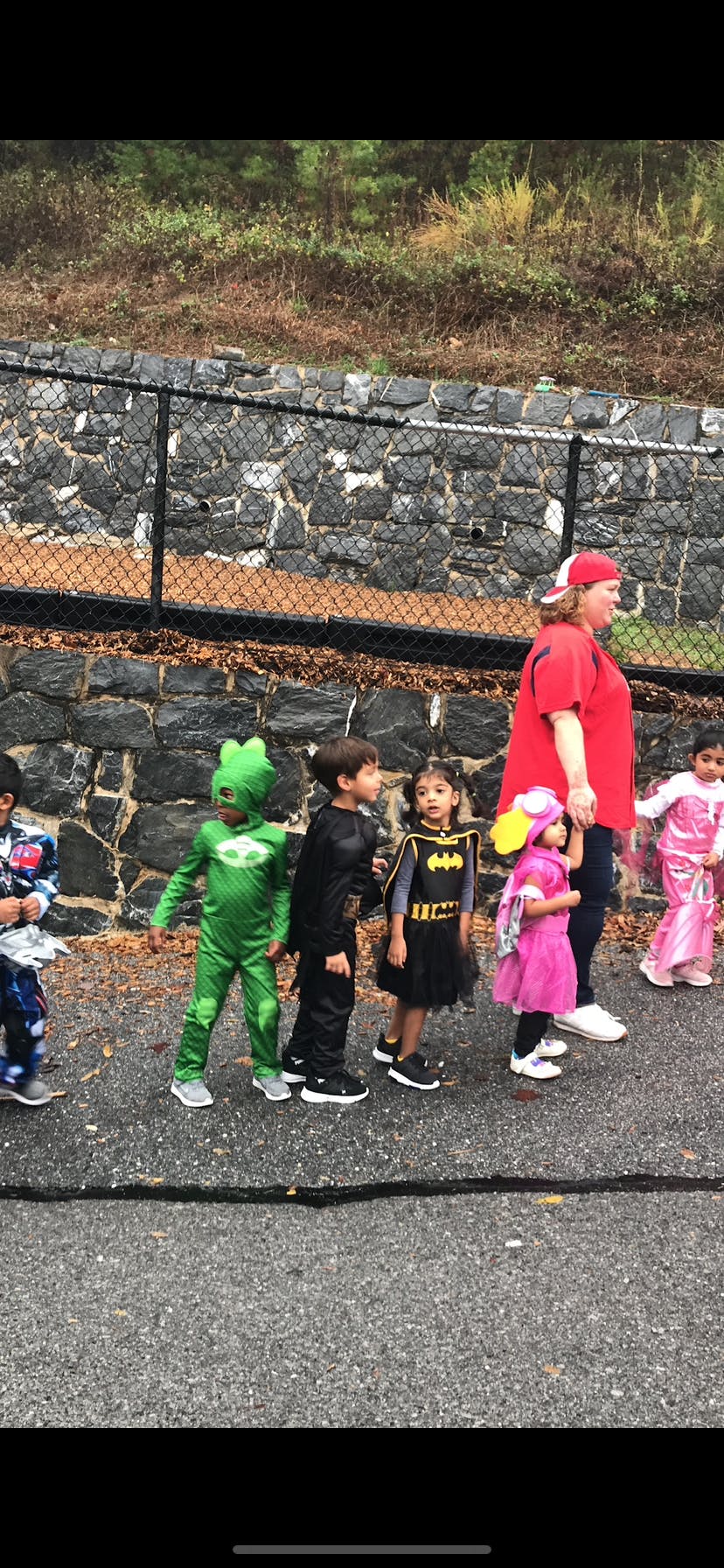 Adult and children in costumes walking outdoors