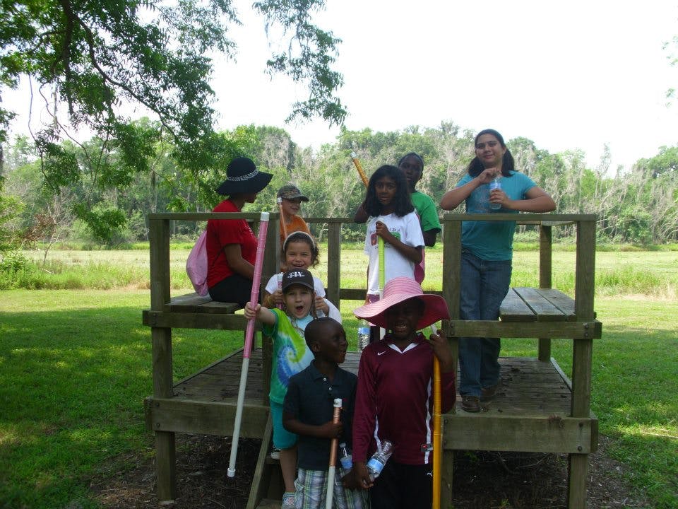 People and children on a wooden structure outdoors