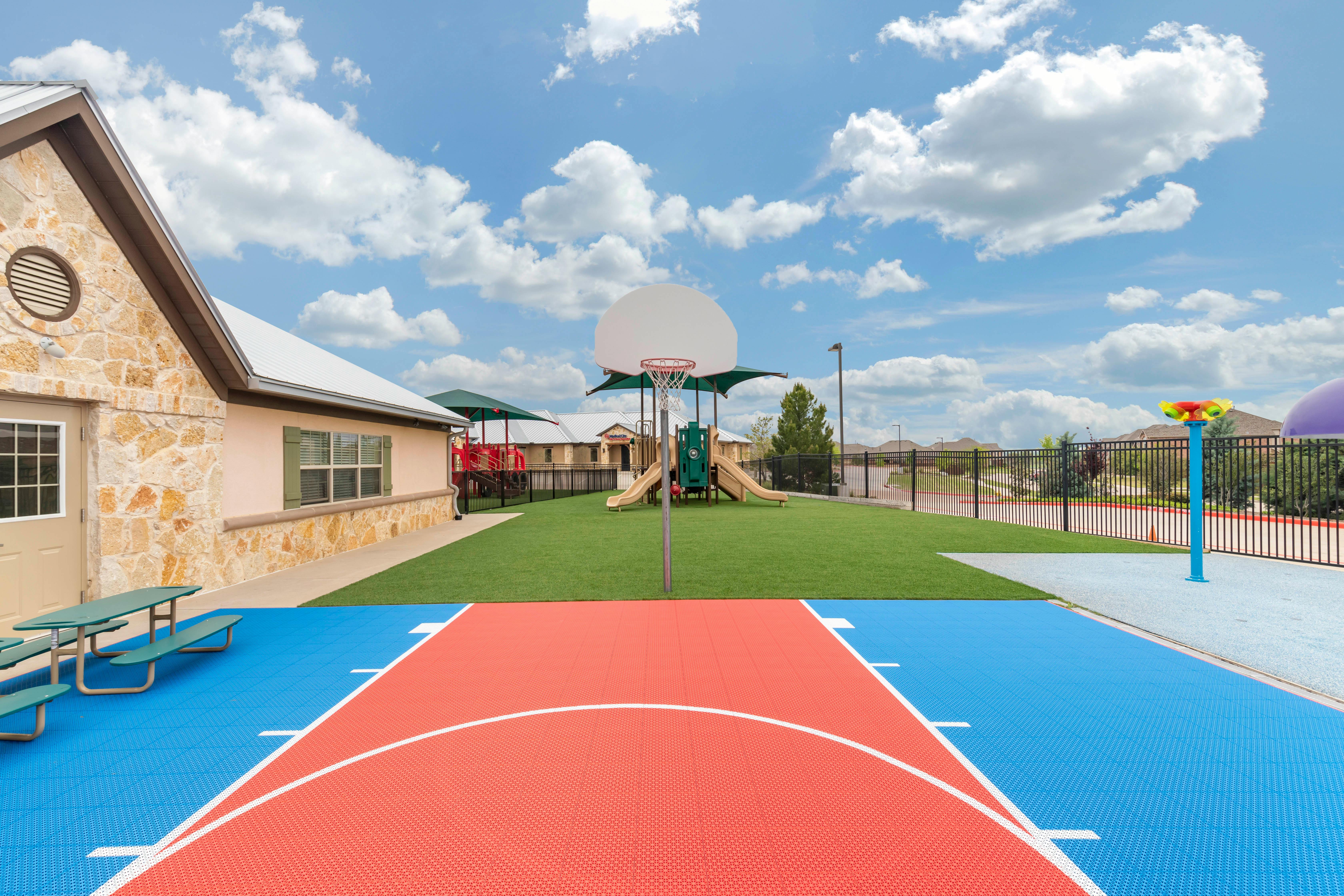 Basketball court with playground in the background