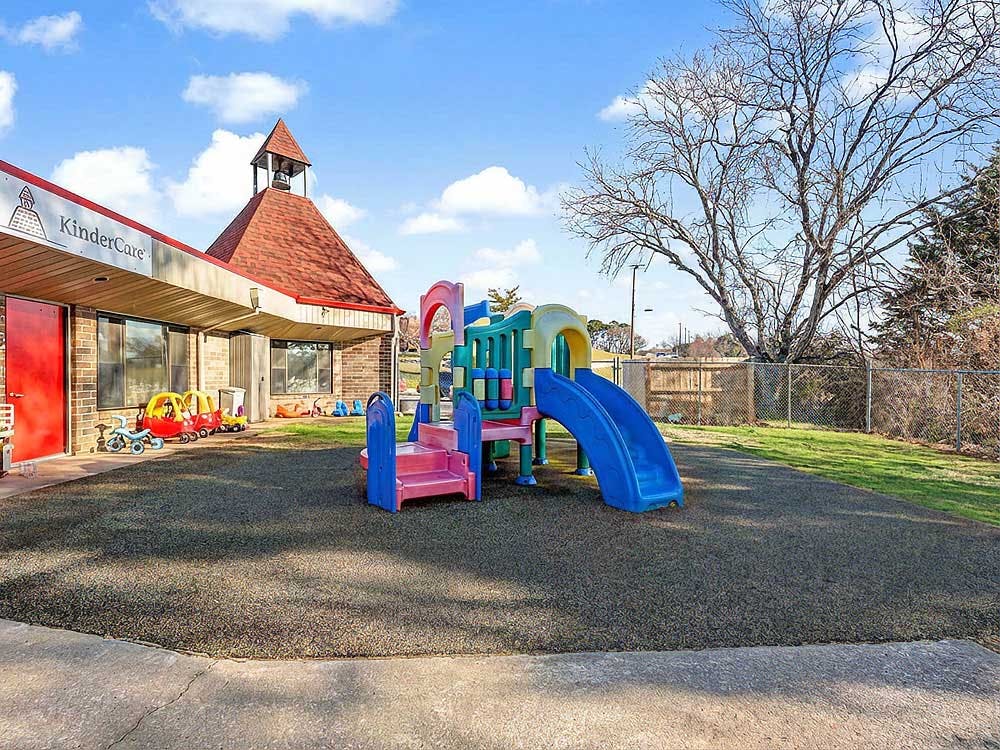 KinderCare building with a colorful playground in front