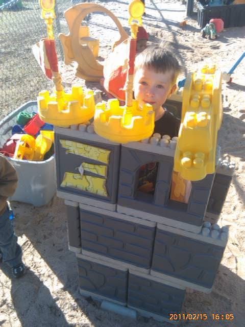 Child playing in a toy castle