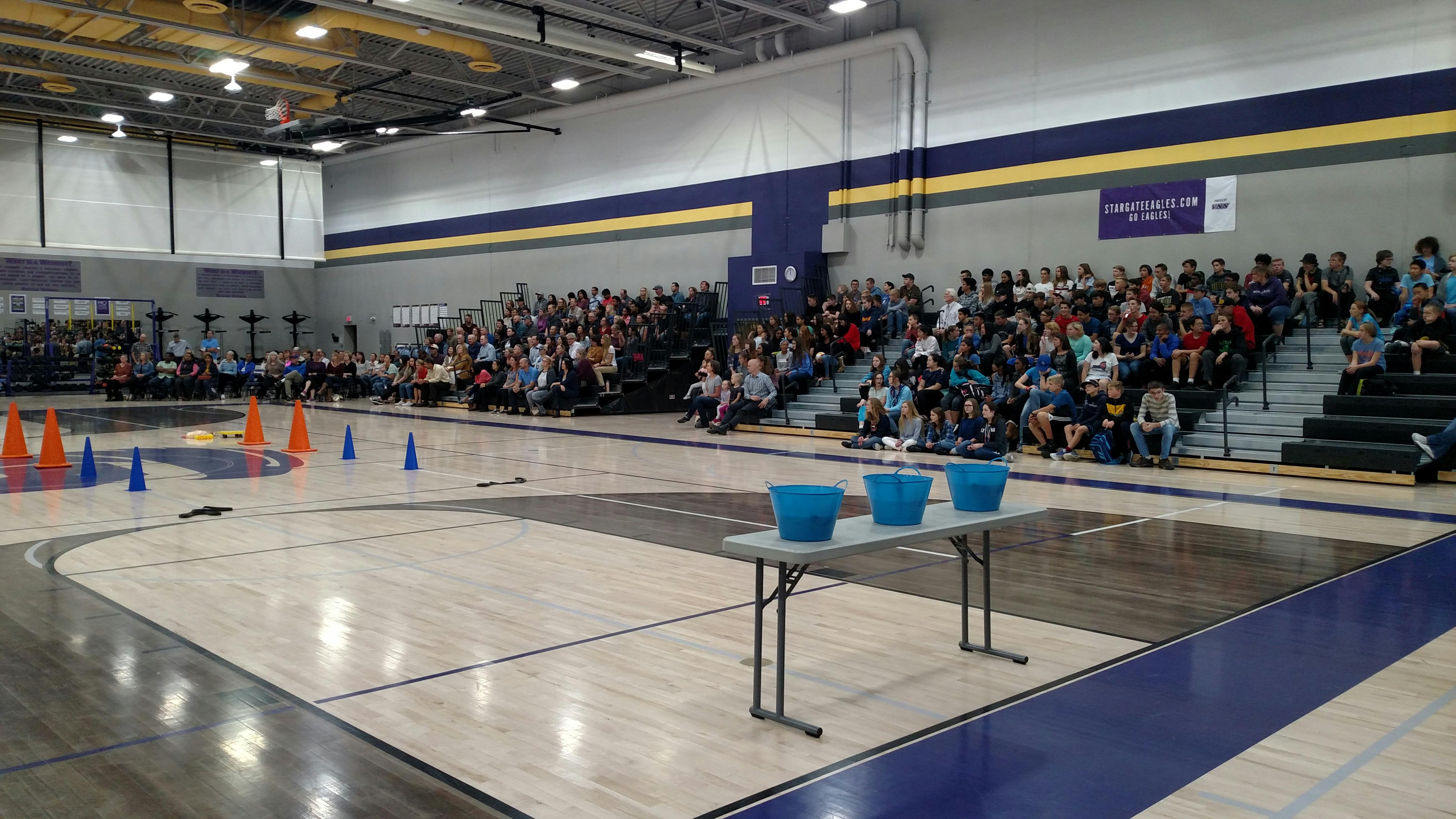 People sitting in bleachers in a gymnasium