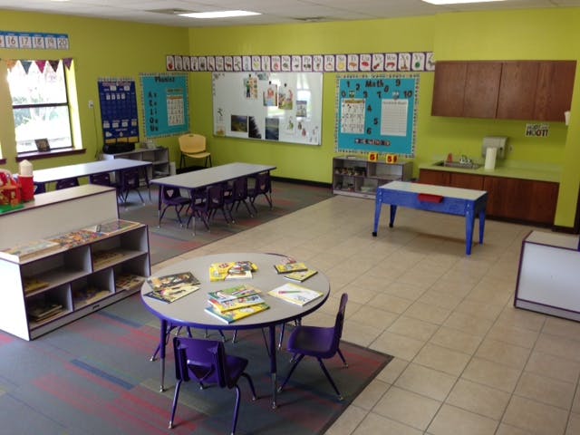 Classroom with tables, chairs, and a whiteboard
