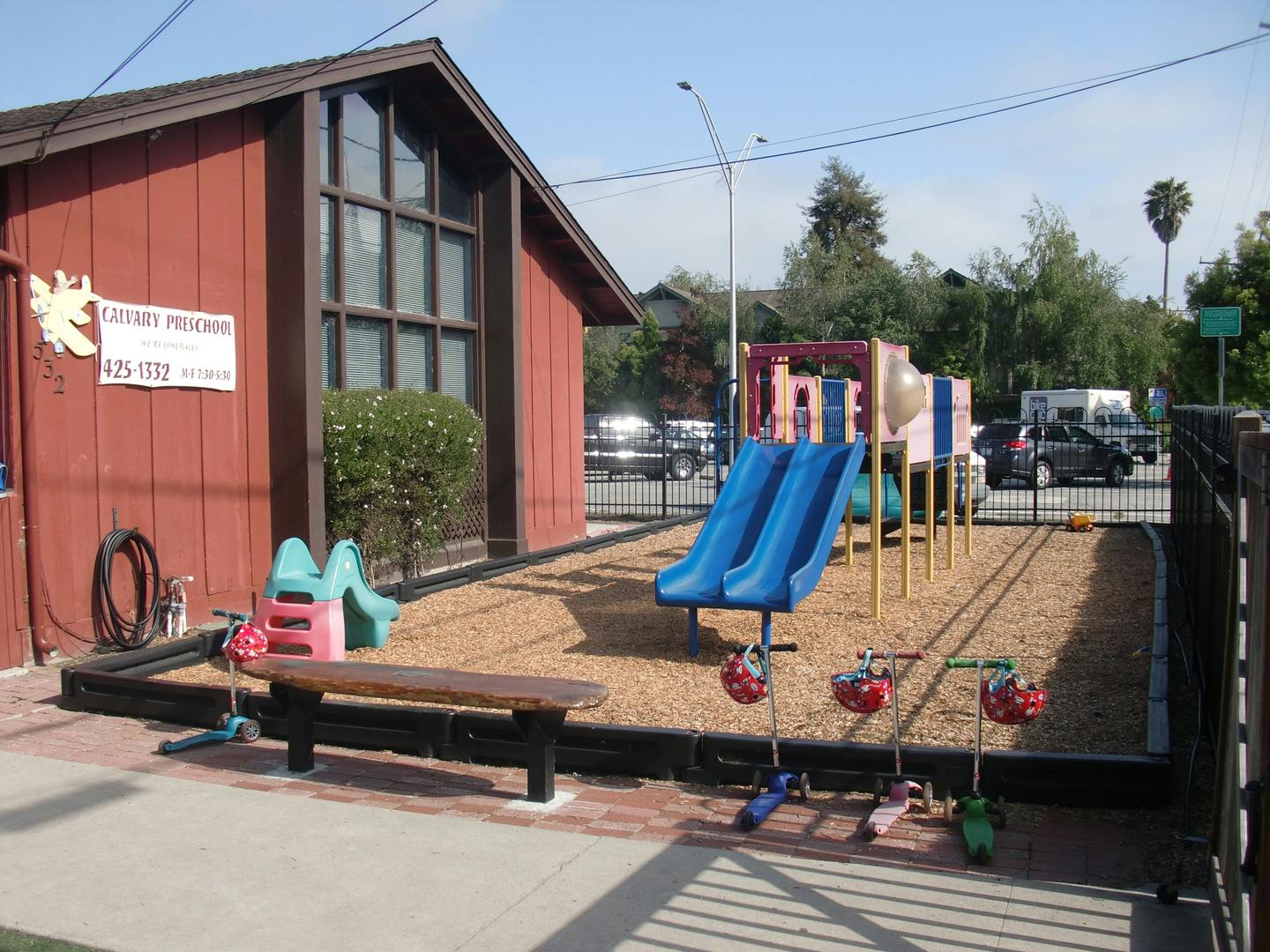 Playground with slides and play structure next to a building