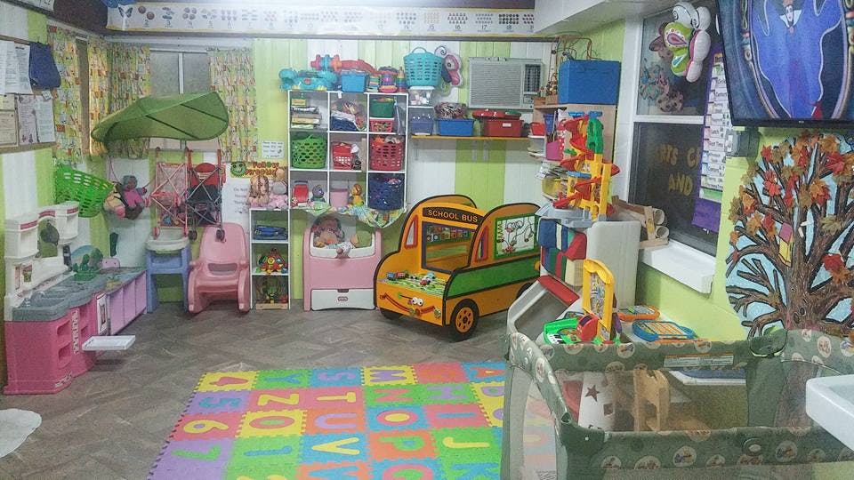 Playroom with toys, play kitchen, and alphabet mat