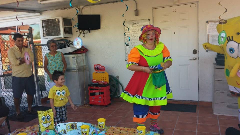 Person in clown costume standing near a person in a Spongebob costume