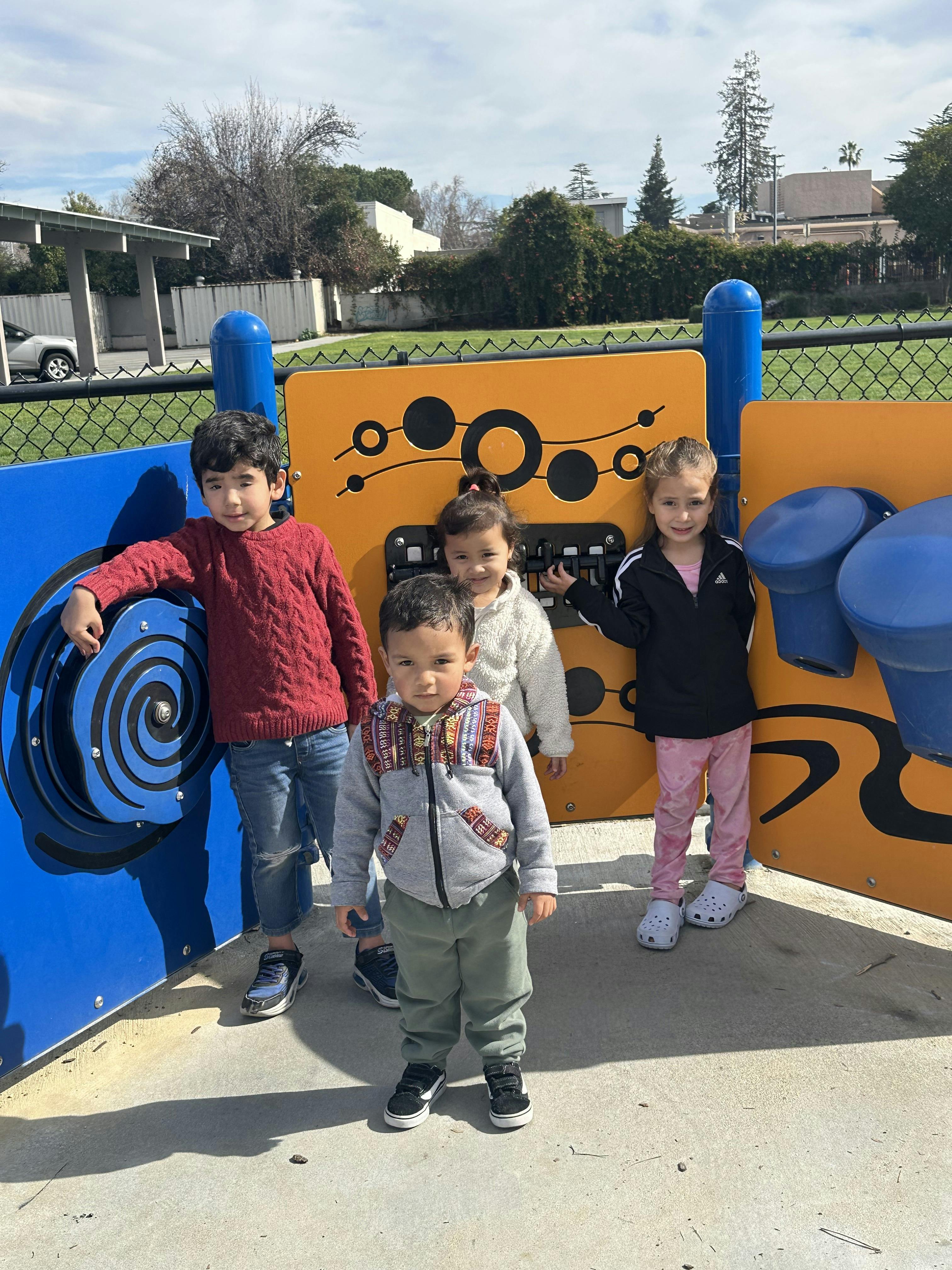 Four children standing on a playground